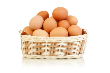 Eggs in basket isolated on white
