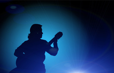 Guy playing the guitar - silhouette