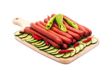 Delicious sausages, served on platter, decorated with vegetables