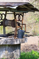 Gray stone well with rope and bucket