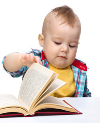 Little child play with book