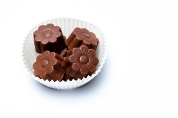 Daisy shaped chocholate assortments in a paper basket