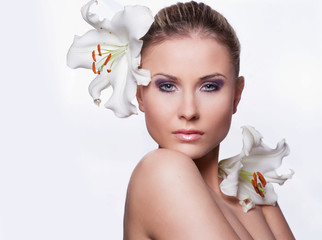 beautiful young woman with flowers on a white background - obrazy, fototapety, plakaty