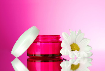 Flower and cream on red background