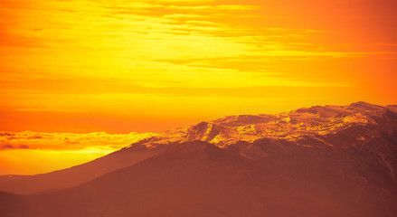 Very beautiful bright orange sunrise over mountains