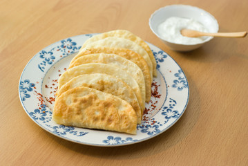 The Tatar meal, pies fried with forcemeat yogurt.