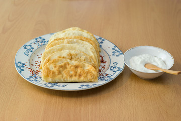 The Tatar meal, pies fried with forcemeat yogurt.