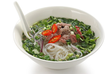 Pho bo , Vietnamese rice noodle soup with sliced rare beef