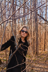 Blond young woman is in the forest