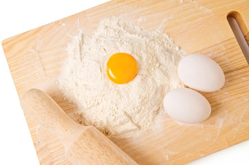 Still life with eggs, flour and wooden board
