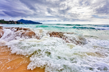 Beautiful tropical beach under gloomy sky.