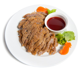 Battered pork with sauce on a plate