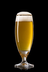 Beer into glass on a black