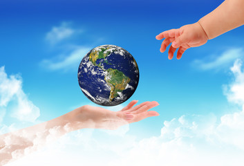 Globe in human hand against blue sky