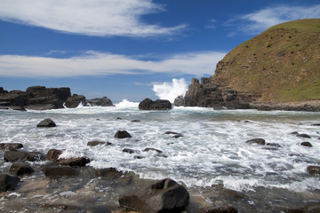Fototapeta na wymiar Landscape of waves blue sky and rocks in sunshine