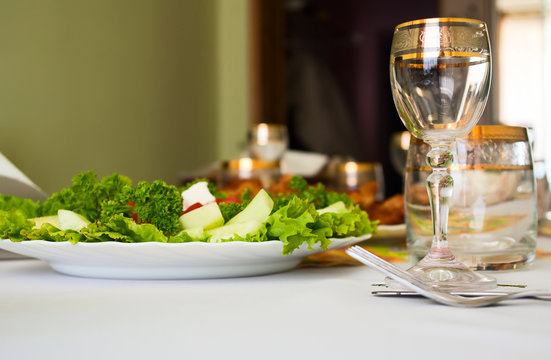 glass and salad on dinner table