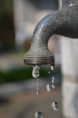 A garden water faucet tap with water drops