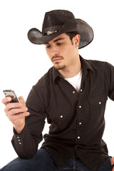 Cowboy looking at phone
