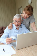 Senior couple doing online shopping