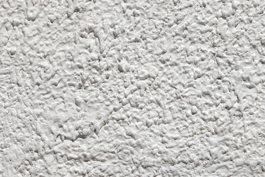 horizontal closeup of white plaster textured wall background