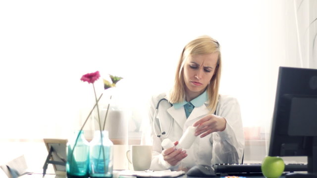 doctor checking checking medications and writing rx prescription