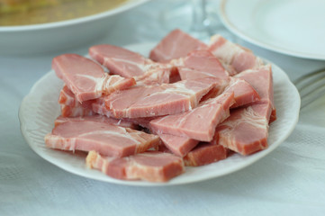 appetizing slices of meat on dinner table