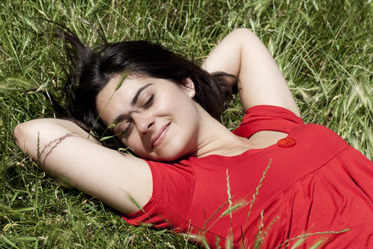 jeune femme couch&eacute;e dans une prairie