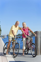 Happy Senior Couple on Bicycles By a River