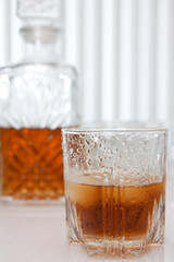 wet glass of whiskey  and crystal decanter