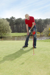 Senior man standing on golf course