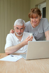Senior couple checking medical information on internet