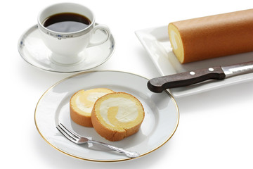 homemade swiss roll with whipped cream and a cup of coffee