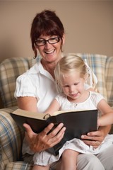 A Grandmother Reading The Bible To Her Granddaughter