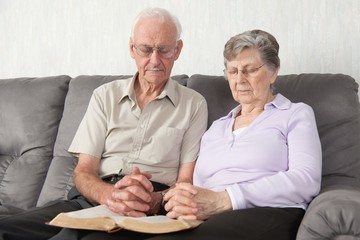 An Elderly Couple Having Worship With The Bible