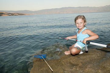 Fishing - girl fishing at the beach