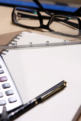 pen ,book, ruler, calculator and glasses