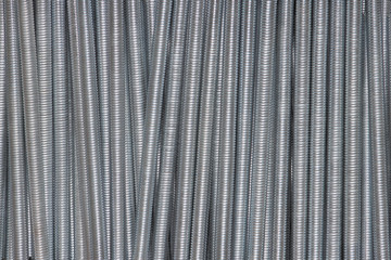 Metal long springs can used as background - obrazy, fototapety, plakaty
