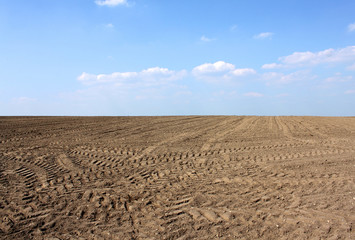 brown soil agriculture earth and blue sky