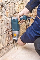 House-builder working with a perforator