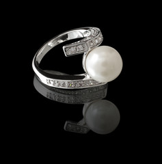 Ring with pearl and diamond on black background