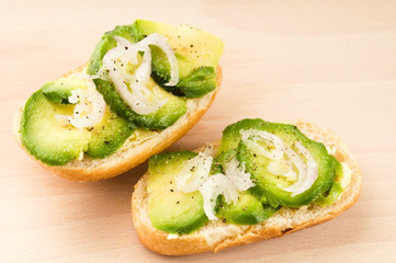 Sandwich with avocado on a wooden board