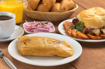 Peruvian breakfast with tamal (cooked corn with meat)