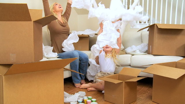 Family Females Playing with  Tissue from Moving Cartons