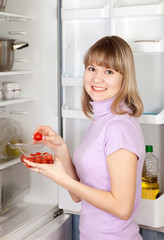 woman taking  Cherry-tomatoes    from refrigerator