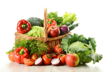 Vegetables in wicker basket  isolated on white
