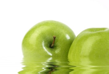 Two green apples on white