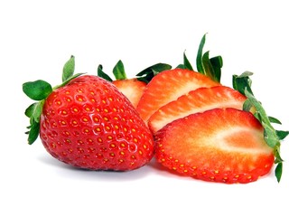 A selection of fresh strawberries sliced and whole
