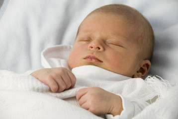 Newborn Baby Boy Aged 9 Days Sleeping in White Blanket