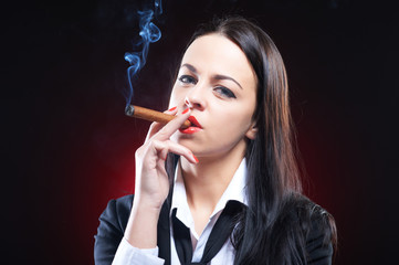 Obraz premium Elegant young woman with cigar