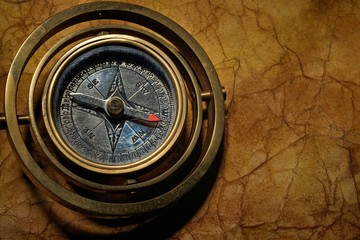 Vintage compass on the old textured paper